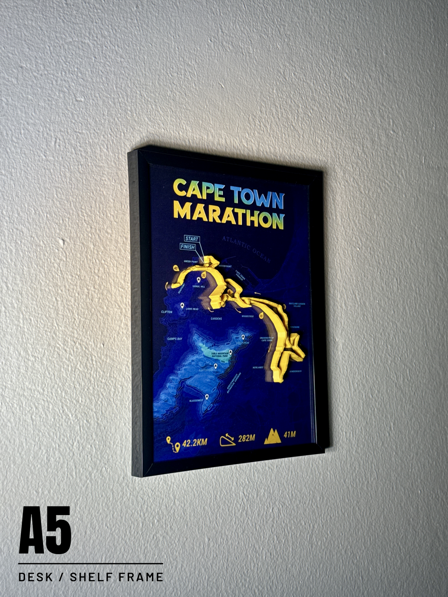 Framed map of Cape Town Marathon on a white wall